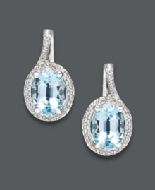 Polish your look with the perfect pair. These elegant oval drop earrings feature a oval-cut blue topaz (3-1/10 ct. t.w.) surrounded by glittering diamond accents. Set in sterling silver. Approximate drop: 3/4 inch. Polish your look with the perfect pair. These elegant oval drop earrings feature a oval-cut blue topaz (3-1/10 ct. t.w.) surrounded by glittering diamond accents. Set in sterling silver. Approximate drop: 3/4 inch.