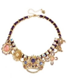 A crowning achievement. This frontal necklace from Betsey Johnson is crafted from gold-tone mixed metal and purple grosgrain ribbon, which provides the foundation for whimsical charms adorned with glass crystal accents. Approximate length: 15 inches + 3-inch extender. Approximate drop: 1-3/4 inches.