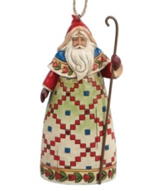 Inspired by traditional tales of St. Nicholas, Jim Shore's Santa figurine wears a beautiful, hand-painted Scandinavian robe and carries a slender staff to symbolize his good-hearted nature. Display standing or hang as an ornament.