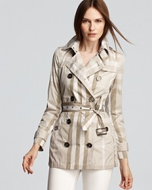 In a classic palette, this short Burberry Alcester trench lends a lightweight layer to mild-weathered days. Pair it with white denim for a crisp look. In a classic palette, this short Burberry Alcester trench lends a lightweight layer to mild-weathered days. Pair it with white denim for a crisp look.