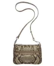 Snake-embossed leather makes this exclusive crossbody purse by Calvin Klein a stellar style option. Remove the strap to carry it as a clutch. Snake-embossed leather makes this exclusive crossbody purse by Calvin Klein a stellar style option. Remove the strap to carry it as a clutch.