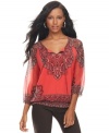 Land a chic casual look with INC's three-quarter-sleeve peasant top, punctuated by a smocked hem.