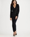 Freeform hearts delineated in shimmering sequins are sprinkled all across the front of a classic cardigan.V neckline Front buttons Long sleeves with ribbed cuffs Ribbed bottom Plain sleeves and back Abut 28 from shoulder to hem 31% nylon/29% viscose/27% cotton/13% wool Dry clean Imported