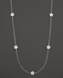 White mother-of-pearl floral stations punctuate this sterling silver link necklace from Lagos.