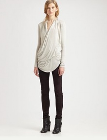 Crossover v-neck and figure-enhancing draping enliven this alarmingly soft jersey top. Crossover draped v-neckLong sleevesCrossover front drapeAsymmetrical hemAbout 31 from shoulder to hemMicromodalDry cleanImportedModel shown is 5'10 (177cm) wearing US size Small.