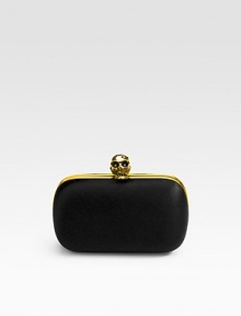 Iconic style with a satin exterior is lined in supple leather and finished with a jewel-encrusted skull. Clip closure Leather lining 6W X 3½H X 2D Made in Italy Iconic style with a satin exterior is lined in supple leather and finished with a jewel-encrusted skull. Clip closure Leather lining 6W X 3½H X 2D Made in Italy