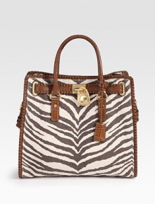 Gorgeous leather whip-stitching edges this roomy top-handle carryall of tiger-print canvas.Double top handles, 4¾ dropAdjustable detachable shoulder strap, 12-13 dropTop snap closureProtective metal feetOne inside zip pocketFour inside open pocketsOne inner hookCotton lining14¼W X 13H X 5½DImported Gorgeous leather whip-stitching edges this roomy top-handle carryall of tiger-print canvas.Double top handles, 4¾ dropAdjustable detachable shoulder strap, 12-13 dropTop snap closureProtective metal feetOne inside zip pocketFour inside open pocketsOne inner hookCotton lining14¼W X 13H X 5½DImported