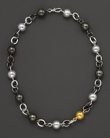 This necklace from Gurhan is all about texture: hammered white silver and dark silver balloon links with a 24 Kt. yellow gold ball.