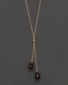 Twin smoky quartz briolettes sparkle from this 14K yellow gold lariat necklace. Twin smoky quartz briolettes sparkle from this 14K yellow gold lariat necklace.