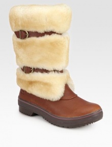 Belt-inspired straps cinch this plush shearling boot with rich leather accents. Shaft, 10¼Leg circumference, 14Shearling and leather upperPull-on style with adjustable leather strapsShearling liningRubber trek solePadded insoleImported