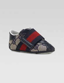 A wide strap in familiar Gucci stripes crosses over a refined sneaker of double G fabric with rich leather accents.GG fabric upperLeather toe, back and accentsWide, striped grip-tape close strapRubber soleMade in Italy A wide strap in familiar Gucci stripes crosses over a refined sneaker of double G fabric with rich leather accents.GG fabric upperLeather toe, back and accentsWide, striped grip-tape close strapRubber soleMade in Italy