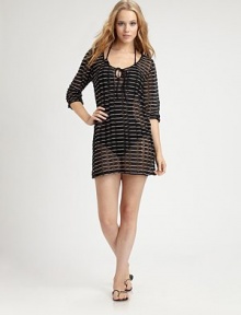 A lacy tunic-length coverup for pretty coverage and rich character on the beach or by the pool.Scoop neckline with drawstring and keyhole openingBelow-the-elbow full sleeves78% polyester/22% spandexHand washImported A lacy tunic-length coverup for pretty coverage and rich character on the beach or by the pool.Scoop neckline with drawstring and keyhole openingBelow-the-elbow full sleeves78% polyester/22% spandexHand washImported