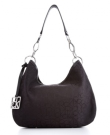 Glossy strap hardware adds reflective shine to this so-now monogram hobo bag from Calvin Klein. Choose from a range of hues, including super-trendy metallic shades. Glossy strap hardware adds reflective shine to this so-now monogram hobo bag from Calvin Klein. Choose from a range of hues, including super-trendy metallic shades.