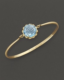 A faceted blue topaz adds brilliant color to gleaming 18K yellow gold. By Carelle.