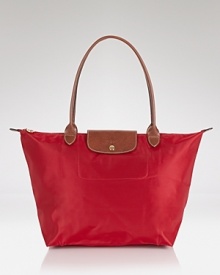 A timeless nod to French style, Longchamp's nylon tote perfects carryall style. This roomy and packable bag is prime for the chic girl, whether she's in-town or overseas. A timeless nod to French style, Longchamp's nylon tote perfects carryall style. This roomy and packable bag is prime for the chic girl, whether she's in-town or overseas.