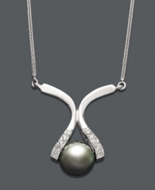 Elegance at its finest. This intricate pendant features a unique 14k white gold setting cradling a cultured Tahitian pearl (8-9 mm). Sides dusted by round-cut diamond accents. Approximate length: 16 inches. Approximate drop: 1 inch.