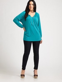 Flattering and feminine, this tunic features an elasticized neckline and cuffs. Its relaxed fit and unique chain detail will make this design one of your favorites.Self-tie necklineDolman sleevesPull-on styleGathered details at backAbout 30 from shoulder to hem95% polyester/5% spandexMachine washImported