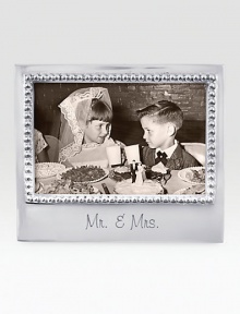 A fitting setting for wedding photos, hand-crafted of recycled aluminum with etched Mr. & Mrs. inscription along the bottom.Accommodates a 4 X 6 photoRecycled aluminum6.75W X 5.75HWipe cleanImported A fitting setting for wedding photos, hand-crafted of recycled aluminum with etched Mr. & Mrs. inscription along the bottom.Accommodates a 4 X 6 photoRecycled aluminum6.75W X 5.75HWipe cleanImported