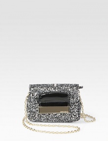 Be the star of the party in this textured, glitter fabric design with patent leather trim and detachable strap.Detachable chain shoulder strap, 23½ dropTop zip closure with flapSatin lining5W X 3½H X 2DMade in Italy Be the star of the party in this textured, glitter fabric design with patent leather trim and detachable strap.Detachable chain shoulder strap, 23½ dropTop zip closure with flapSatin lining5W X 3½H X 2DMade in Italy
