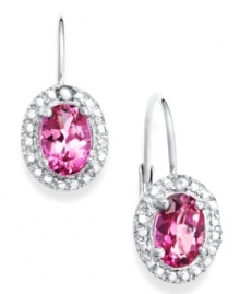 Pink perfection. Victoria Townsend's sparkling drop earrings highlight oval-cut pink topaz (2-1/5 ct. t.w.) surrounded by round-cut diamond accents. Set in sterling silver. Approximate drop: 3/4 inch.