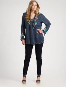 Colorful embroidery creates a lively effect for this peasant blouse with an elongating silhouette. Self-tie necklineLong sleevesEmbroidered detailsPull-on styleAbout 32 from shoulder to hemRayonMachine washImported