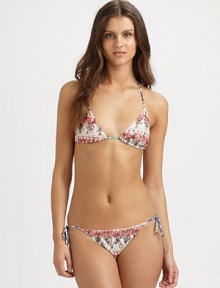 A pretty muted print meets a classic swim design with self-tie details for an impeccable fit.Halter strap ties at neckTriangle cupsStretch bottomSide tiesRayonHand washMade in Italy