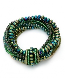 Mesmerizing color from c.A.K.e. by Ali Khan. This stylish stretch bracelet combines multiple rows of glass faceted rondelles, bugle beads and seed beads in green hues. Bracelet stretches to fit wrist. Approximate diameter: 2 inches.