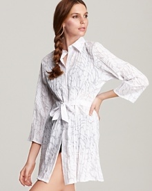 A crisp white button down looks fresh for any occasion -- even over your favorite swimwear. This Miraclesuit tunic ties at the waist for effortless elegance.