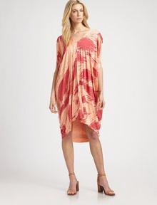 Vibrantly printed jersey in a caftan-inspired silhouette with an asymmetrical hi-low hem, short dolman sleeves and a plunging v-back. V-neckShort dolman sleevesAsymmetrical hi-low hemPlunging v-backAbout 28 from natural waist92% modal/8% spandexDry cleanMade in USAModel shown is 5'10 (177cm) wearing US size Small.