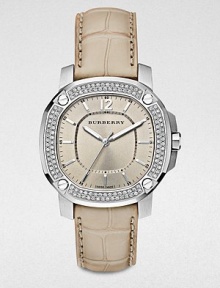 An dazzling timepiece with a diamond bezel on a brushed, grey stainless steel case and a luxurious alligator strap. Quartz movementWater resistant to 5 ATMOctagonal stainless steel case, 38mm (1.5) Diamond and screw accented bezel, 00 tcwNude dialBar and numeric hour markersSecond hand Trench alligator strapMade in Switzerland 