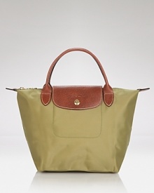Longchamp's signature nylon tote in a miniature size lends sophisticated chic to every look, from city jaunts to weekend getaways. Folds up for ease during travel. Longchamp's signature nylon tote in a miniature size lends sophisticated chic to every look, from city jaunts to weekend getaways. Folds up for ease during travel.