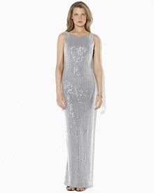 Capturing timeless elegance in a sweeping floor-length silhouette, the evening gown is tailored with a sequined mesh overlay and a sexy cowled back for an alluring finish.