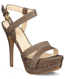 Teeter along in this tall, sexy style. The Geary platform sandals by GUESS feature a sparkly fabric upper with wrap-around ankle strap enclosure and side buckle.