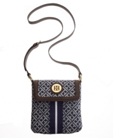 Keep it classic with this tasteful crossbody from Tommy Hilfiger. A timeless signature exterior features a preppy stripe at center and iconic goldtone hardware at front. Keep it classic with this tasteful crossbody from Tommy Hilfiger. A timeless signature exterior features a preppy stripe at center and iconic goldtone hardware at front.