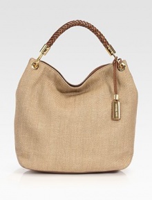 Incredibly roomy in cotton canvas, topped with a chic woven leather handle.Top handle, 9¼ dropMagnetic snap closureOne inside zip pocketTwo inside open pocketsCotton lining19W X 13½H X 6DImported