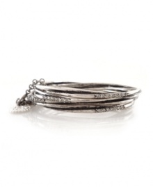 Add sleek sophistication with stackable bangles. From the Jessica Simpson collection, bracelet set features oxidized silvertone mixed metal bangles which can be held together with a 3-inch attachment chain, or worn separately. Each bangle features a row of seven round-cut crystal accents. Approximate diameter: 2-3/4 inches.