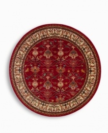 A larger-diameter round that is ideal for oversized rooms. In homage to renowned artist William Morris, this rug features his signature vine and pomegranate motifs framed by an acanthus leaf border inspired by a Morris & Co. tapestry. A special dyeing process imparts subtle shadings to a dynamic palette of blues, greens, terra cotta, saffron yellow and ivory tones on a warm red ground. The resulting striated effect recreates the depth of hue achieved by aged vegetable dyes. Woven of premium worsted wool and finished with a patented luster wash for indulgent softness.