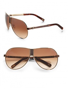 THE LOOKNavigator style Metal framesLogo etched lens Logo temples Lizard-embossed bridge and temples Signature case includedTHE COLORGoldtone with brown gradient lensesORIGINMade in Italy THE LOOKNavigator style Metal framesLogo etched lens Logo temples Lizard-embossed bridge and temples Signature case includedTHE COLORGoldtone with brown gradient lensesORIGINMade in Italy