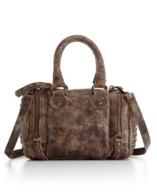 This classic satchel silhouette by Frye gets a western-inspired makeover. A distressed exterior with signature hardware and side zip pockets gives this style a rugged yet refined appeal. This classic satchel silhouette by Frye gets a western-inspired makeover. A distressed exterior with signature hardware and side zip pockets gives this style a rugged yet refined appeal.