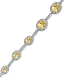 The perfect finishing touch. Eliot Danori's gorgeous all-around bracelet shines with oval-cut cubic zirconia (12-1/2 ct. t.w.) and smaller, round-cut glass crystal. Set in rhodium-plated mixed metal. Approximate length: 7-1/4 inches.