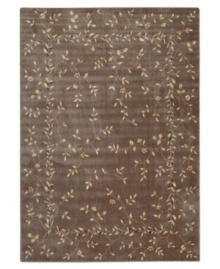 A beautiful lattice of delicate vines and blooming flowers gives this rug its magnetic charm. On a dark khaki ground with soft ivory accents, this densely woven piece invites you into wonderful interior decor.