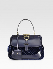 Black diamante velvet and black leatherDark blue diamante velvet and dark blue leatherBlack suede liningAntique gold hardwareTop handle with 5.5 dropHand covered leather frame closureStud detailSpur with engraved logoFront gusset pocketDetachable mini purse with snap closureInterior zip and open pocket with gold embossed crestProtective metal feetMedium size: 12.6W X 9.4H X 5.7DMade in Italy