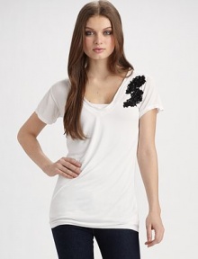 A wardrobe constant goes from simple to sophisticated, with its beautifully embellished lace appliqué.V-neck Pullover style Short sleeves Floral lace appliqué with sequins and beads About 27¼ from shoulder to hem Modal; hand wash Imported