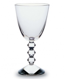 The Vega collection of wine glasses will make a unique and striking addition to your finely set table. Each piece features a neck lined with thick connecting diamond-shaped glass studs leading from the commanding sturdy base to the simple bulb, lending a look that has the timeless effect and appeal of glittering diamonds. The Vega collection of wine glasses will make a unique and striking addition to your finely set table. Each piece features a neck lined with thick connecting diamond-shaped glass studs leading from the commanding sturdy base to the simple bulb, lending a look that has the timeless effect and appeal of glittering diamonds.