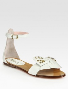 Soft lambskin sandals with an adjustable ankle strap and stud embellishments, fronted by an oversized bow. Studded lambskin upperLeather lining and soleMade in ItalyOUR FIT MODEL RECOMMENDS ordering one half size down as this style runs large. 