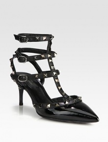 Strong point toe silhouette of patent leather with signature metal studs on adjustable leather straps. Self-covered heel, 2¾ (70mm)Patent leather upper with metal studded leather trimPoint toeThree adjustable ankle strapsLeather lining and solePadded insoleMade in Italy