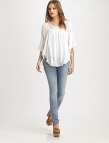 Utter romance in this light and flowy peasant blouse styled with soft ruffles and eyelet trim.Tie-front split V-neckDropped shouldersThree-quarter sleevesGathered bodiceShirttail hemRayonDry cleanImportedModel shown is 5'8½ (174cm) wearing US size Small.