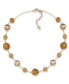 Golden rules. Gold-hued glass pearls are complemented by alluring amber-colored fireball accents on Carolee's chic illusion necklace. Made in gold tone mixed metal, it will add polish to your workday wardrobe. Approximate length: 16 inches + 2-inch extender. Golden rules. Gold-hued glass pearls are complemented by alluring amber-colored fireball accents on Carolee's chic illusion necklace. Made in gold tone mixed metal, it will add polish to your workday wardrobe. Approximate length: 16 inches + 2-inch extender.