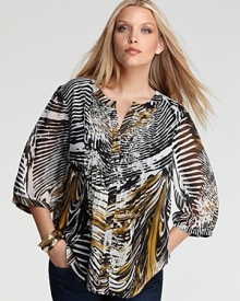 A breezy silhouette enlivens a vibrantly printed Calvin Klein top for a chic approach to bohemian style.