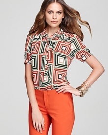 With a graphic print and chic neck tie, this VINCE CAMUTO blouse channels '70s-chic. Slip the bold style into color-pop pants for vintage polish.